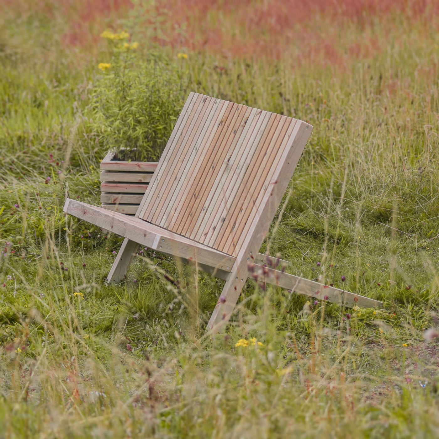 Rustic Garden Bench in a lush green garden. Made from durable fsc-timber. 