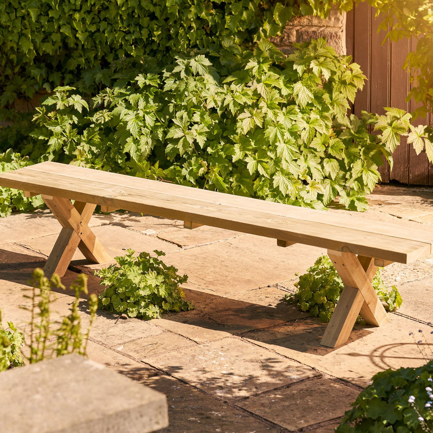 This chunky rustic farmhouse style garden bench is handcrafted from FSC-certified sustainable timber, features a bold 45mm thick top and x shaped legs.