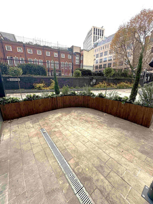 Bespoke outdoor bar area with curved duty planters and seating