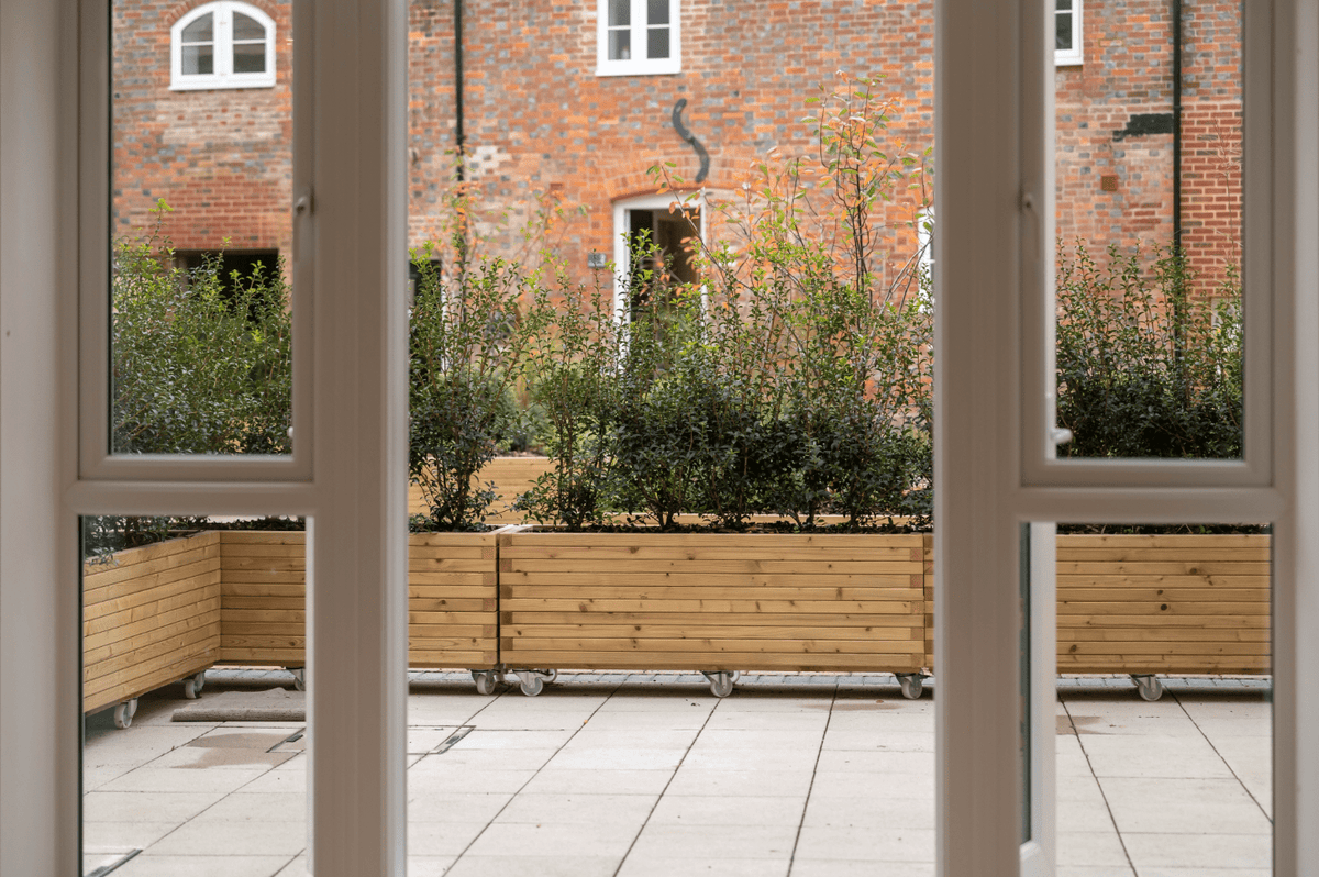 Courtyard planters with built-in seating for Brewhouse Yard