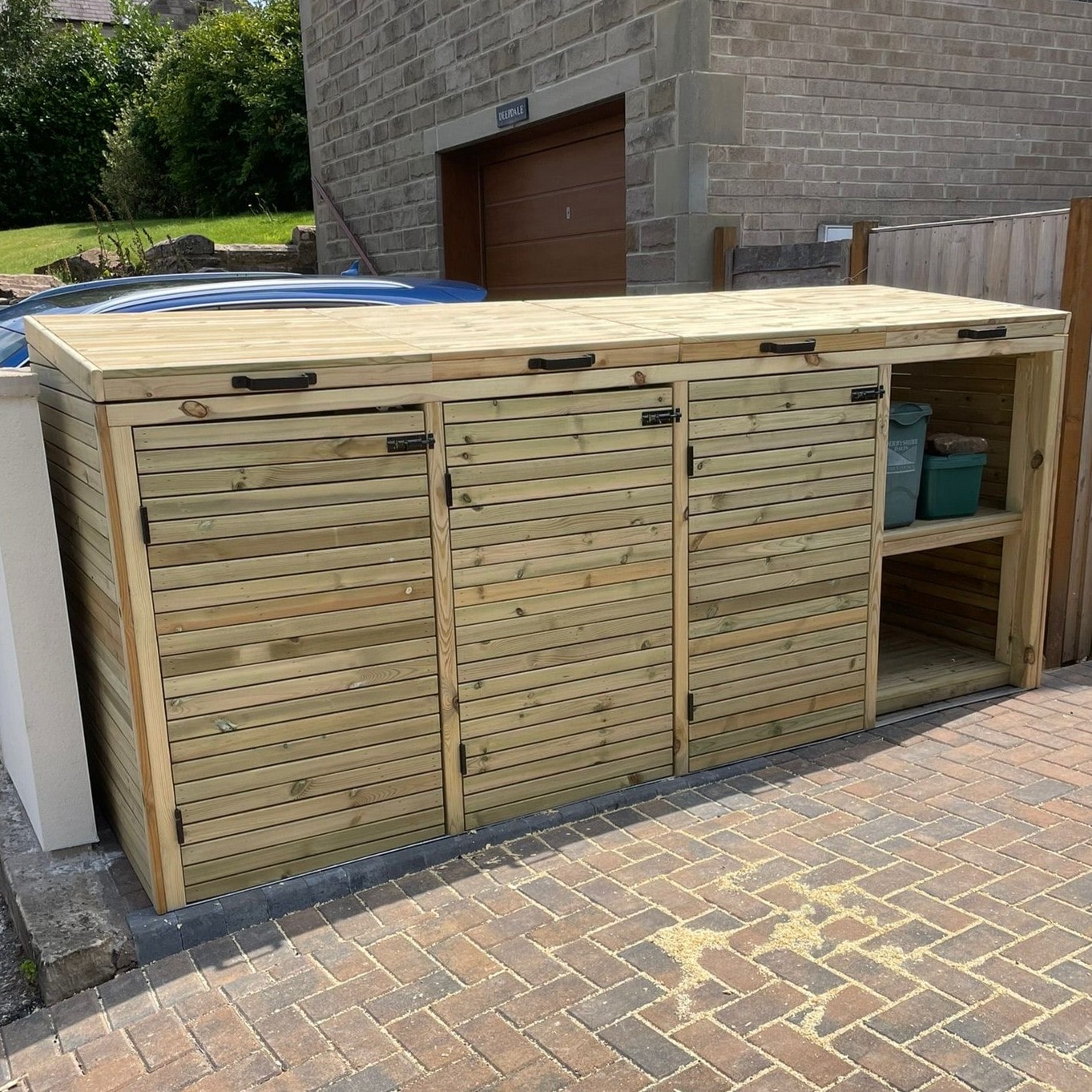 Wooden wheelie bin store with tiled roof and parcel bay, handcrafted timber bin storage.