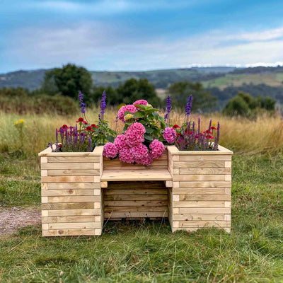  A beautiful wooden planter bench filled with vibrant flowers. The planter bench is made of high-quality timber and has a slatted design. It's perfect for adding a touch of greenery and seating to any outdoor space.