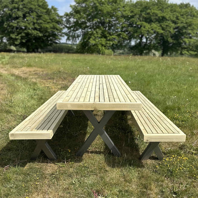 Wooden garden dining set with steel X legs in a rustic style, featuring a slatted tabletop and full-length benches.
