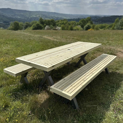 Outdoor wooden garden dining set with steel X legs placed in a garden, perfect for family meals or commercial spaces.