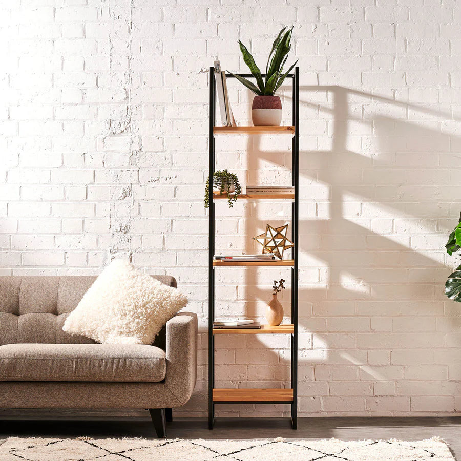 Modern bespoke ladder-style shelving unit with solid oak shelves and black metal frame in a living room.